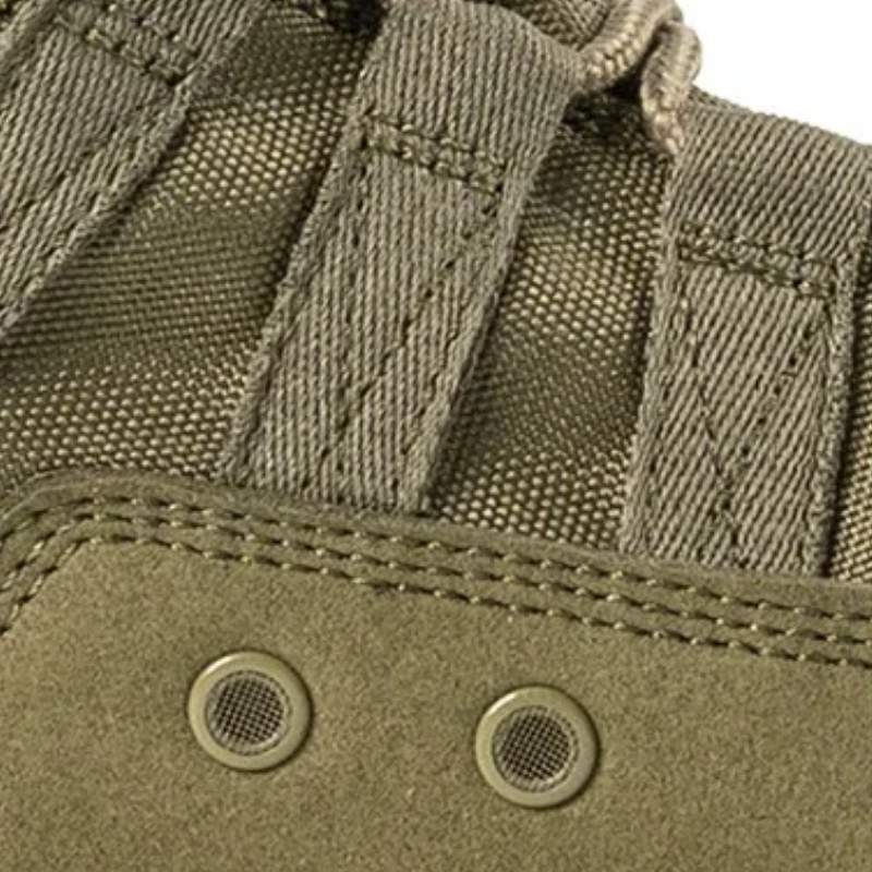 Gros plan sur le tissu des chaussures rangers commando vertes avec focus sur deux trous d’aération, assurant respirabilité et confort en conditions extrêmes
